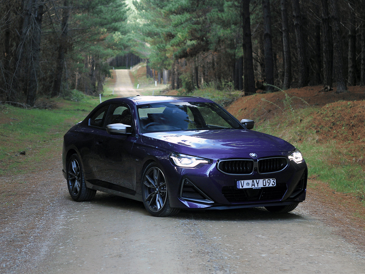 2022 bmw m240i on dirt road front quarter